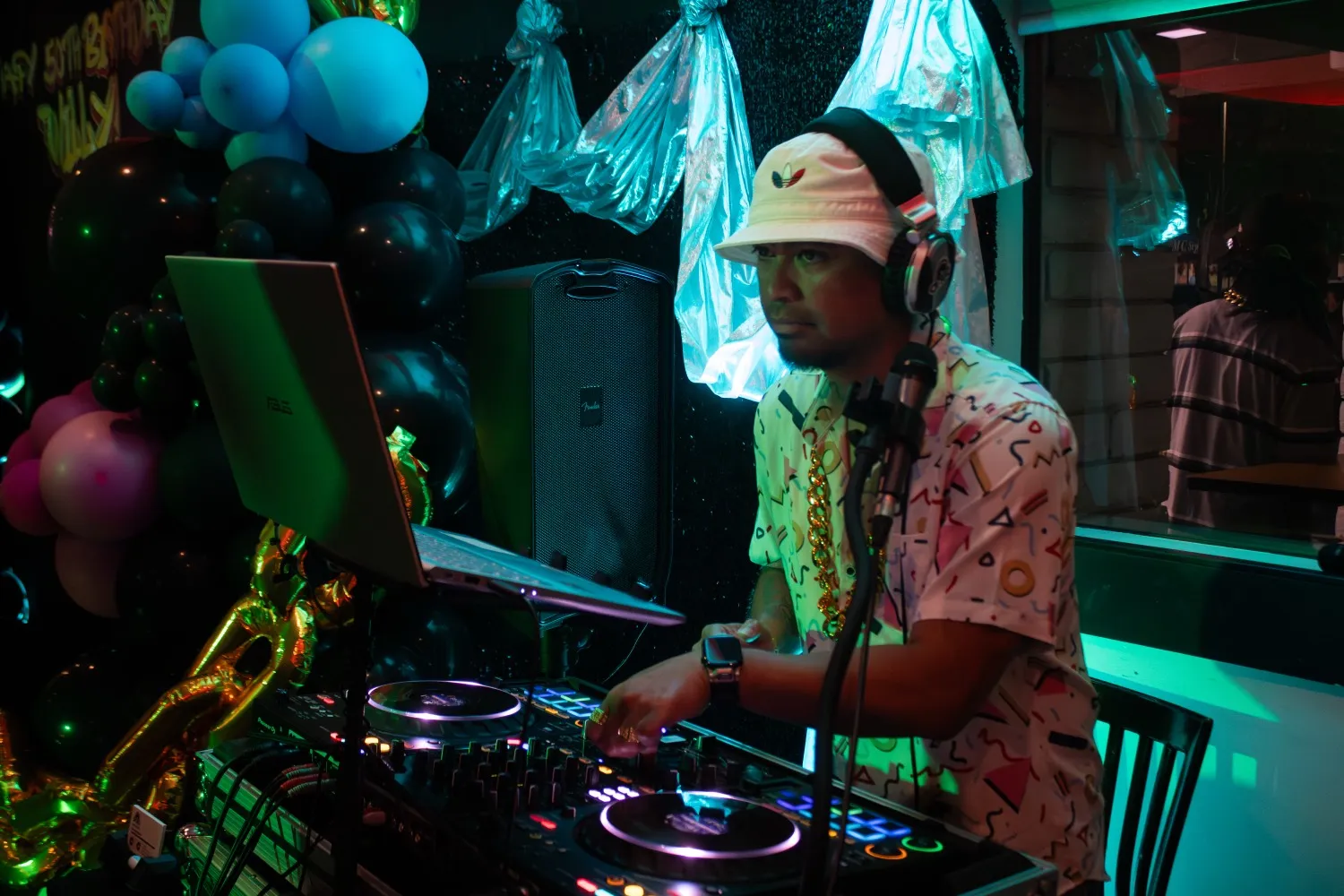 DNSB DJ reading the room behind the decks under stage lights